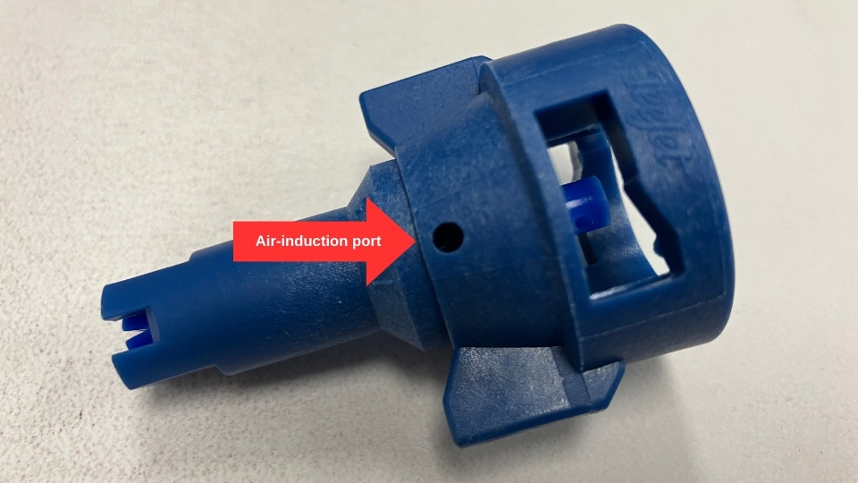 Close-up of a blue spray nozzle used for specific applications.