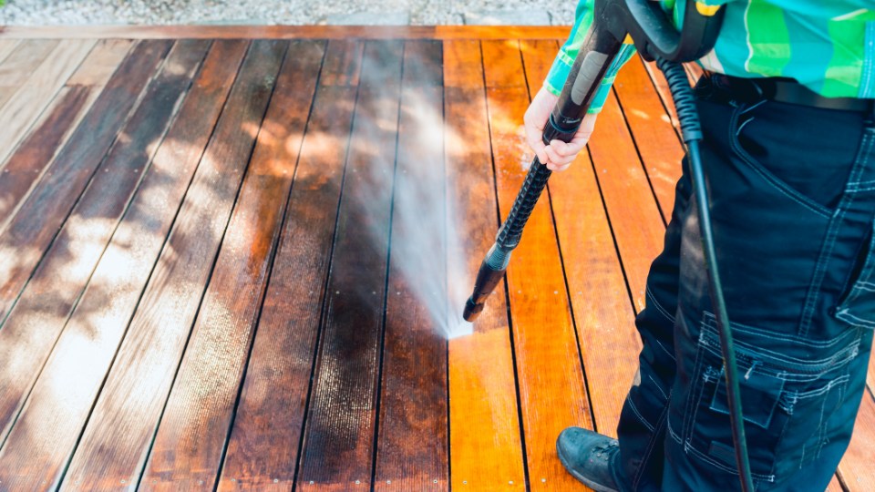 High-pressure water spray removing grime and film from a surface.